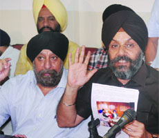 DSGMC president Manjit Singh G.K. with senior vice-president Ravinder Singh Khurana addresses a press conference in New Delhi on Tuesday.