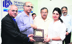 Chartered Secretary R Sridharan, president, Institute of Company Secretaries of India (ICSI), honours a student during a seminar at DAV College in Jalandhar on Tuesday. Photo Sarabjit Singh