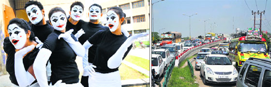 Masked talent: Students pose after participating in a mime competition at the University of Jammu on Tuesday; (right) Motionless motors: A traffic jam on a flyover in Jammu on Tuesday.
