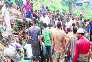 Army personnel along with locals trying to dig out bodies from debris in Dhok Bagla village of Rajouri.