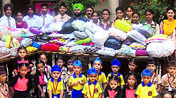 Students of Guru Gobind Singh Public School collect relief material for the flood-hit in J&K