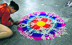 A student makes rangoli during the Panjab University Zonal Youth and Heritage Festival at the Government College for Girls in Ludhiana on Tuesday