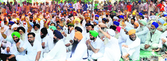 People protest on the Amloh-Khanna road in Fatehgarh Sahib. Tribune file photo