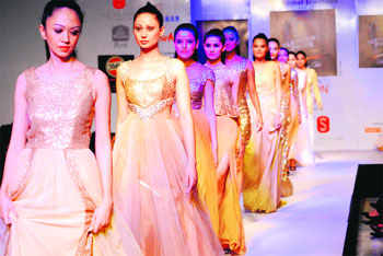 Models walk on the ramp during the Dehradun Fashion Week in Dehradun on Monday.