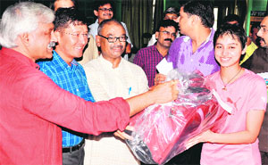 Sports Minister Dinesh Aggarwal felicitates players at the prize distribution ceremony of the East Zone Inter-State Badminton Championship at the ctiy sports complex in Haridwar on Tuesday.