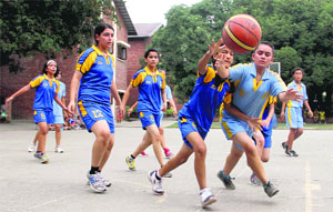 Players vie to take control of the ball in a match in the DDSCA Junior Girls U-15 Basketball Tourament at Welham Girls School in Dehradun on Tuesday. 
