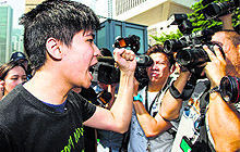 Hong Kong Federation of Students deputy Lester Shum (L) shouts slogans outside the Chief Executive headquarters in Hong Kong on Tuesday