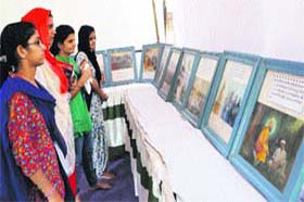 Students look at still photographs and historical documents at an exhibition organised by the GNDU in Amritsar on Wednesday
