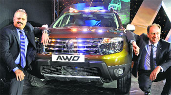 Renault India officials pose with Duster All Wheel Drive at its launch in New Delhi on Wednesday. It is priced between Rs 11.89 lakh and Rs 12.99 lakh.