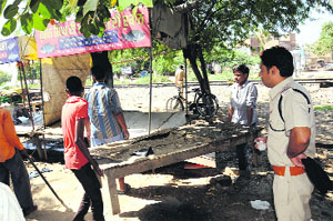 Railway police officials remove encroachments near the Patiala phatak in Bathinda on Wednesday. 