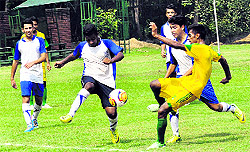 Players of the Mahilpur Football Academy and Delhi Public School vie for the ball during a match of the 12th Administrators Challenge Cup Football Tournament at the football stadium in Sector 42, Chandigarh, on Wednesday