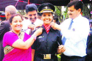 The parents of Ekshita Rana pin stars on the uniform of their daughter in Chennai.