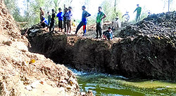 Villagers supervise a breach on the Hajin-Sopore road to drain out the floodwaters from apple orchards