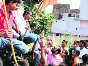 Police try to get protesters off the engine of a goods train at Domorhia Bridge in Ludhiana on Wednesday.