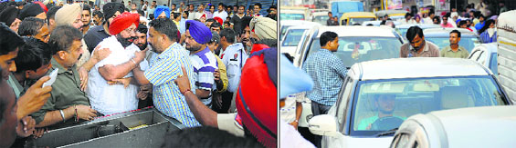 Shopkeepers argue with the tehbazaari wing officials and police personnel; and (right) vehicles stuck in a jam during the drive at Field Ganj in Ludhiana on Wednesday.