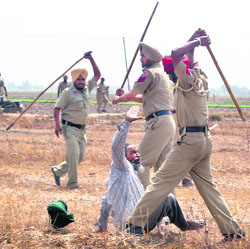 A protesting lineman being lathicharged