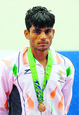 Dushyant poses with his bronze medal on Wednesday