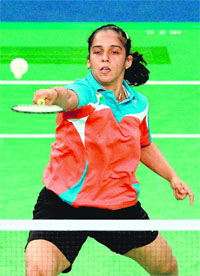 Saina Nehwal goes for a drop shot against Macaus Teng Lok during their opening round match on Wednesday. Saina won 21-10, 21-8. PV Sindhu won 21-7, 21-13 against Wong Kit Leng, also of Macau. 