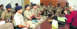 Forest Minister Dinesh Aggarwal holds a meeting with police officers in Dehradun on Wednesday. A Tribune photograph