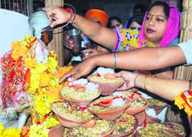 Devotees offer prayers on the Navaratri festival at the Mata Longa Wali Devi temple in Amritsar on Thursday