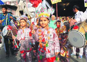 Children dressed up as langoor dance to the beats of dhols at Hanuman Temple in Durgiana Mandir, Amritsar, on Thursday