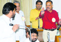 BJP councillor Arun Sood (in red shirt) raises a point during an MC meeting on Thursday. Tribune photo: Pradeep Tewari
