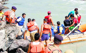 Divers search for a car that drowned in the Beas in Mandi on Wednesday.