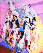 A devotee pays obeisance before the idol of Mahishasur Mardini at Tara Mandir in Kangra on Thursday. 