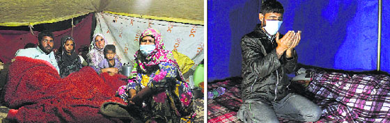A family takes shelter in a tent; and (right) a man prays inside a tent on the Srinagar-Jammu bypass. Tribune photos 