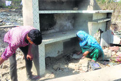 Shakeela and her brother look at what remains of their house in Kulgam village. A Tribune Photo 