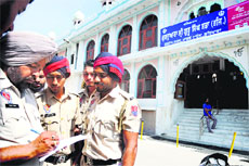 A police official takes down details of the incident outside a gurdwara at Model Town in Ludhiana.
