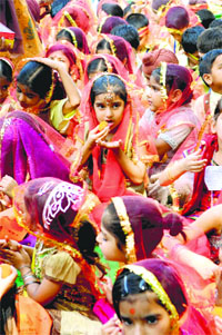 Girls partake of parsad during Kanjak Puja on the first Navratra at Geeta Mata Mandir in Ludhiana on Thursday
