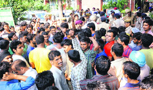 Traders of the vegetable and fruit market hold a protest in Sector 26, Chandigarh, on Friday.