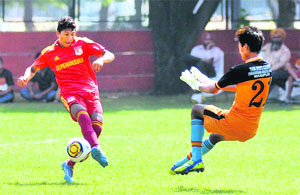 Players vie for the ball during a match of the Administrators Challengers Cup at the Sector 17 football stadium in Chandigarh on Friday.