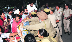Police personnel try to stop student leaders from entering the Administrative Block at Panjab University in Chandigarh on Friday.