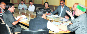 Chief Minister Virbhadra Singh presides over a meeting in Shimla on Friday. A Tribune photo