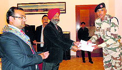 Davinder Singh, DIG, ITBP Academy, gives a certificate to a donor at a blood donation camp in Mussoorie on Friday
