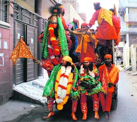 Devotees heading to take part in Langoor Mela ride an auto meant for transporting merchandise in Amritsar on Saturday