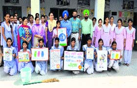 District Education Officer (Secondary) Satinderbir Singh cleans school premises along with students during the launch of Swachh Bharat Abhiyaan at Government Girls Secondary School, the Mall, in Amritsar on Saturday