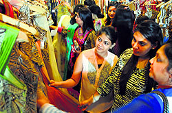 Visitors have a look at designer wear during a sale at Maharaja Hotel in Ludhiana