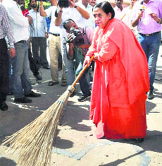 Union Minister Uma Bharti sweeps as she takes part in the Swachh Bharat Abhiyan  in New Delhi on Friday.