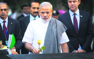 Prime Minister Narendra Modi places a rose in the memory of an Indian victim of the 9/11 attack at Ground Zero in New York on Saturday. 