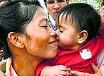 Mary Kom kisses her child after winning her round of 16 bout on Saturday