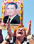 A supporter of former Egyptian President Hosni Mubarak shouts slogans near a picture of Mubarak outside a police academy on the outskirts of Cairo on Saturday