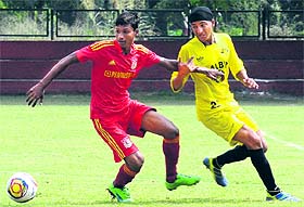 Players in action during a football match between Pune and Patiala at Sector 17, Chandigarh, on Sunday.