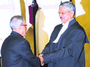President Pranab Mukherjee greets CJI HL Dattu at Rashtrapati Bhavan in New Delhi on Sunday.