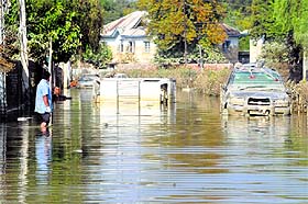 A man wades through a waterlogged street in the Jawahar Nagar area of Srinagar on Sunday.