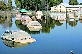 Damaged vehicles submerged at the Joggers Park in the Rajbagh area of Srinagar on Sunday.