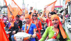 Members of the Bajrang Dal hold a motorcycle rally against love jihad at Clock Tower in Dehradun on Sunday