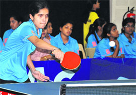 A girl plays a shot during a match in the IPSE Inter-School Table Tennis Tournament at Welham Girls School